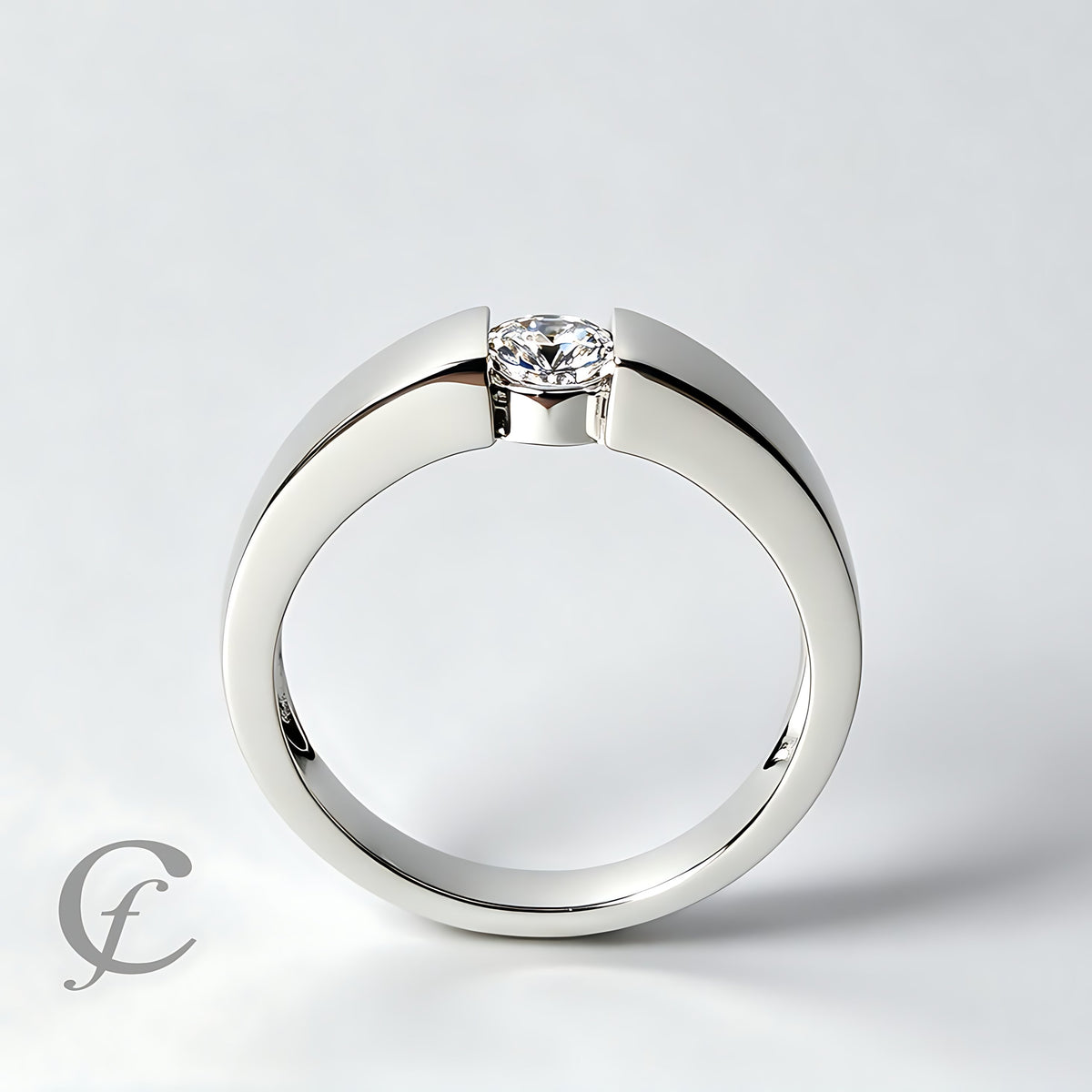 A polished silver-tone ring with a single round clear gemstone in a prong setting, photographed on a clean light gray background.