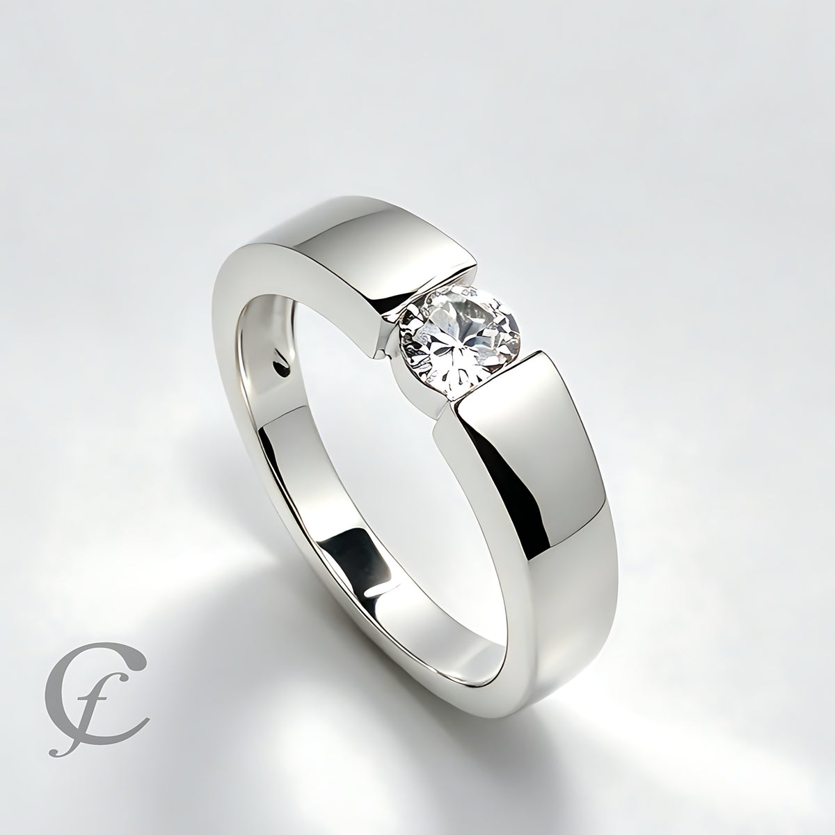 A polished silver-tone ring with a round clear gemstone in a prong setting, shown on a clean light gray background.