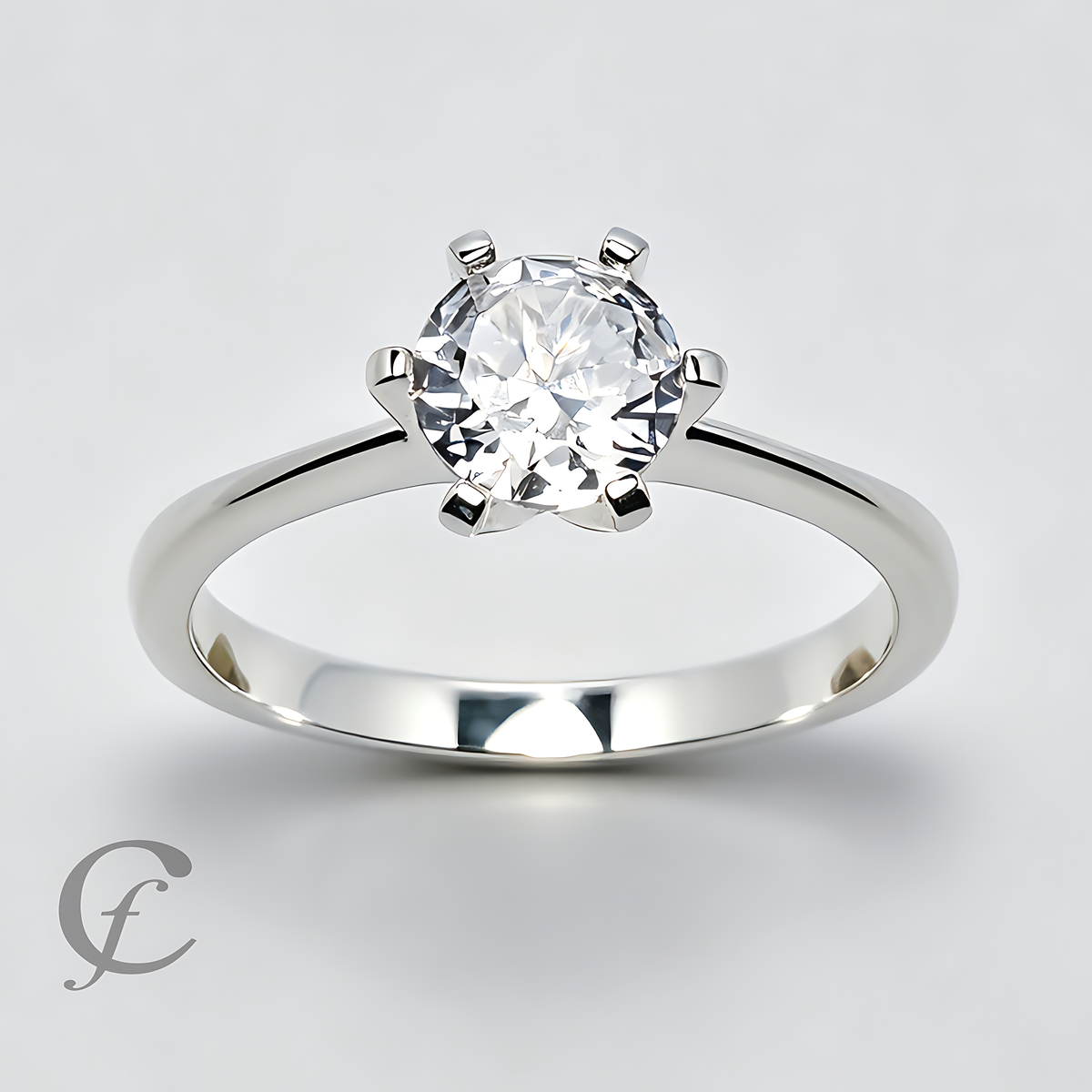 A classic solitaire engagement ring featuring a round brilliant-cut diamond set in a polished sterling silver six-prong setting, shown on a light gray background.