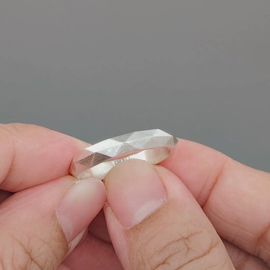 Modern faceted wedding band handcrafted from solid 925 sterling silver with a satin finish. Features a minimalist geometric design, optional engraving, multiple sizes, and no plating or coating for authentic sterling silver beauty.